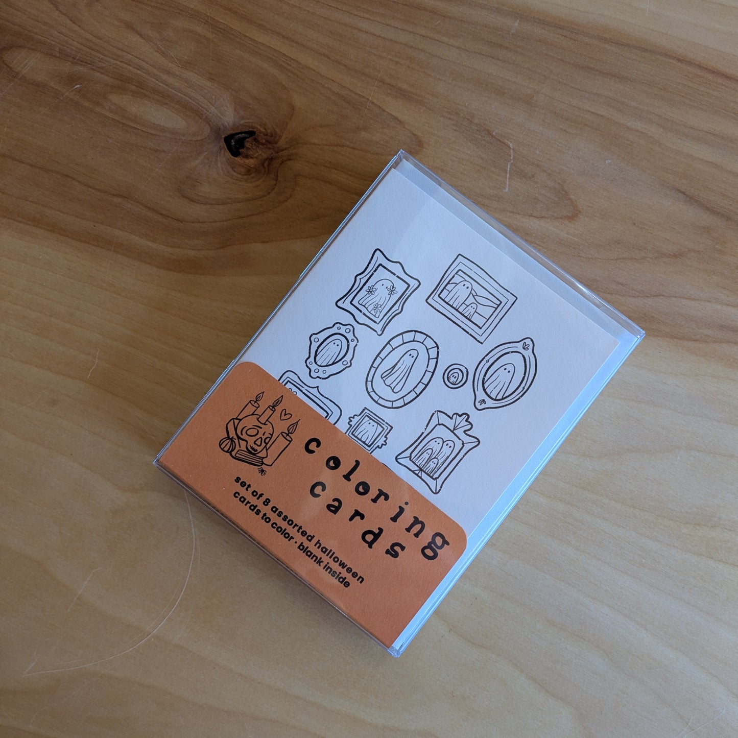 Box of coloring cards on a wooden surface