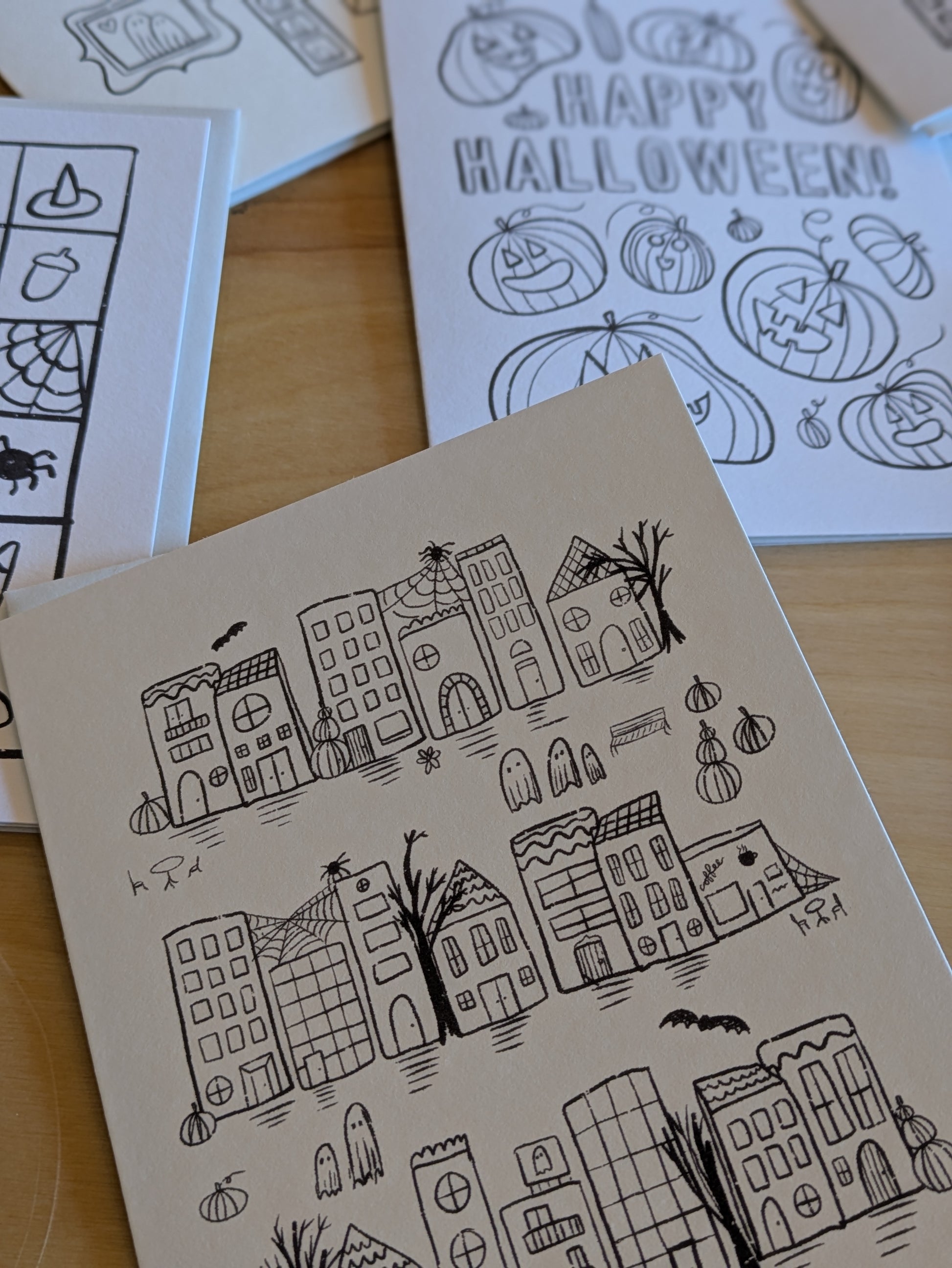 Halloween-themed coloring page with black line art on white pages.